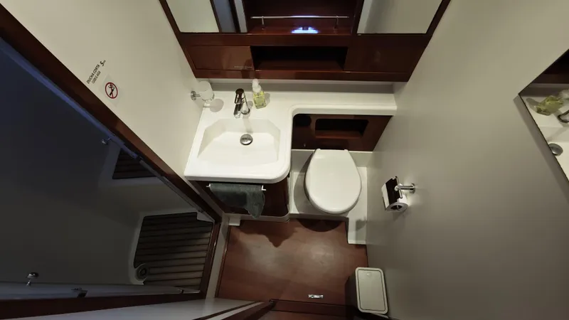 Beneteau Swift Trawler 52 Yacht Photos Pics Bathroom interior of 2011 Beneteau Swift Trawler 52, featuring sink and toilet.