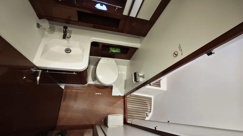 Beneteau Swift Trawler 52 Yacht Photos Pics Bathroom interior of 2011 Beneteau Swift Trawler 52, featuring sink and toilet.
