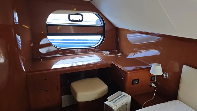 Beneteau Swift Trawler 52 Yacht Photos Pics 2011 Beneteau Swift Trawler 52 cabin with desk, window, and wooden interior.