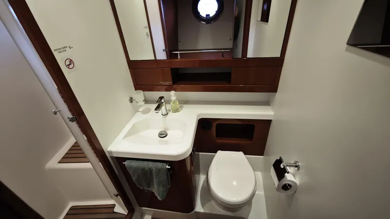 Beneteau Swift Trawler 52 Yacht Photos Pics Bathroom interior of 2011 Beneteau Swift Trawler 52, featuring sink, toilet, and mirror.