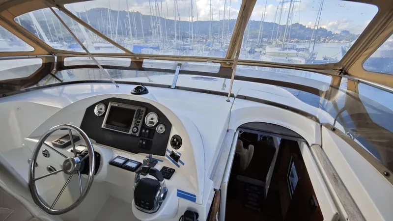 Beneteau Swift Trawler 52 Yacht Photos Pics Helm of 2011 Beneteau Swift Trawler 52 with marina view through windows.