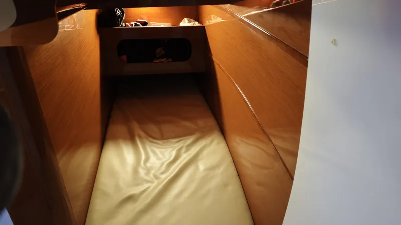 Beneteau Swift Trawler 52 Yacht Photos Pics Interior cabin of 2011 Beneteau Swift Trawler 52 with wooden finish and cozy bedding.