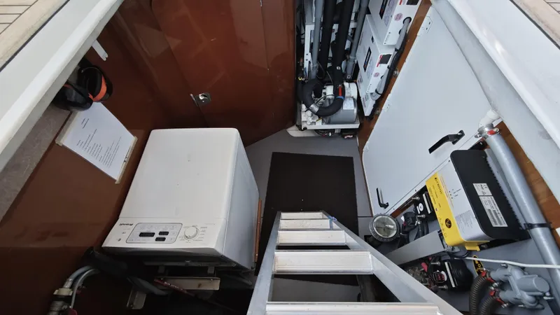 Beneteau Swift Trawler 52 Yacht Photos Pics Engine room of 2011 Beneteau Swift Trawler 52 with equipment and access ladder.