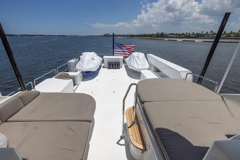 Seahawk Yacht Photos Pics Luxurious 2014 Westport Motoryacht deck with seating, American flag, and ocean view.