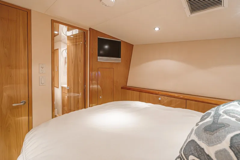 Whiplash II Yacht Photos Pics Luxurious cabin interior of 2006 Hatteras 50 Convertible yacht with wood finishes and modern amenities.