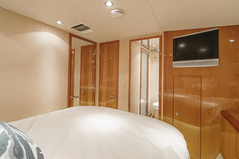 Whiplash II Yacht Photos Pics Luxurious cabin interior of 2006 Hatteras 50 Convertible yacht with wood paneling and TV.