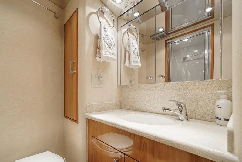 Whiplash II Yacht Photos Pics Luxurious bathroom in 2006 Hatteras 50 Convertible yacht with modern fixtures and elegant design.