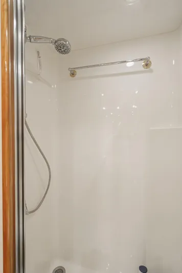 Whiplash II Yacht Photos Pics Shower area in 2006 Hatteras 50 Convertible yacht, featuring chrome fixtures and white walls.