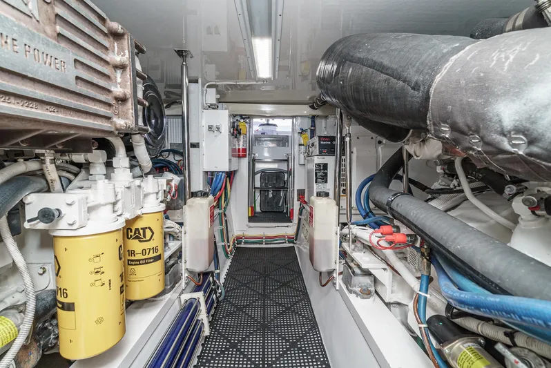 Whiplash II Yacht Photos Pics Engine room of 2006 Hatteras 50 Convertible yacht, featuring CAT components and organized layout.