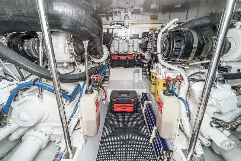 Whiplash II Yacht Photos Pics Engine room of 2006 Hatteras 50 Convertible yacht, showcasing mechanical components and equipment.