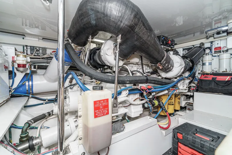Whiplash II Yacht Photos Pics Engine room of 2006 Hatteras 50 Convertible yacht, showcasing complex machinery and components.