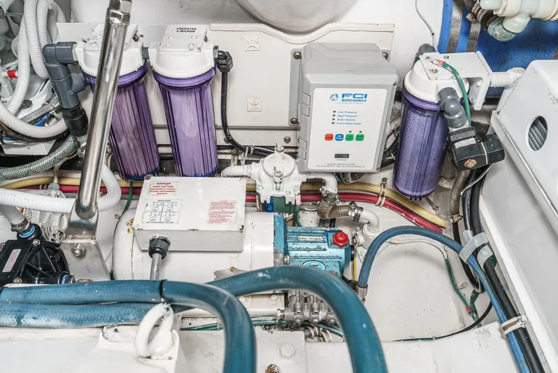 Whiplash II Yacht Photos Pics Engine room of a 2006 Hatteras 50 Convertible with filtration system and control panel.