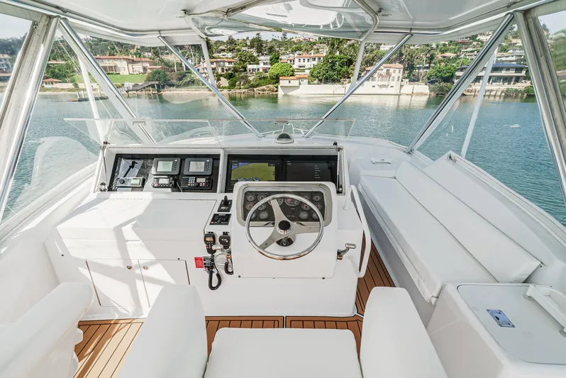 Whiplash II Yacht Photos Pics Helm of 2006 Hatteras 50 Convertible yacht with scenic waterfront view.