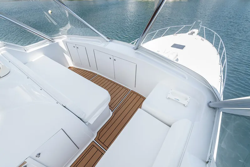 Whiplash II Yacht Photos Pics 2006 Hatteras 50 Convertible yacht deck with white seating and wooden flooring.