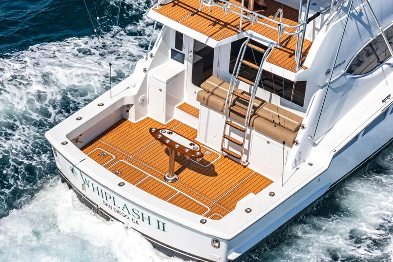 Whiplash II Yacht Photos Pics 2006 Hatteras 50 Convertible yacht with teak deck, cruising on ocean waters.