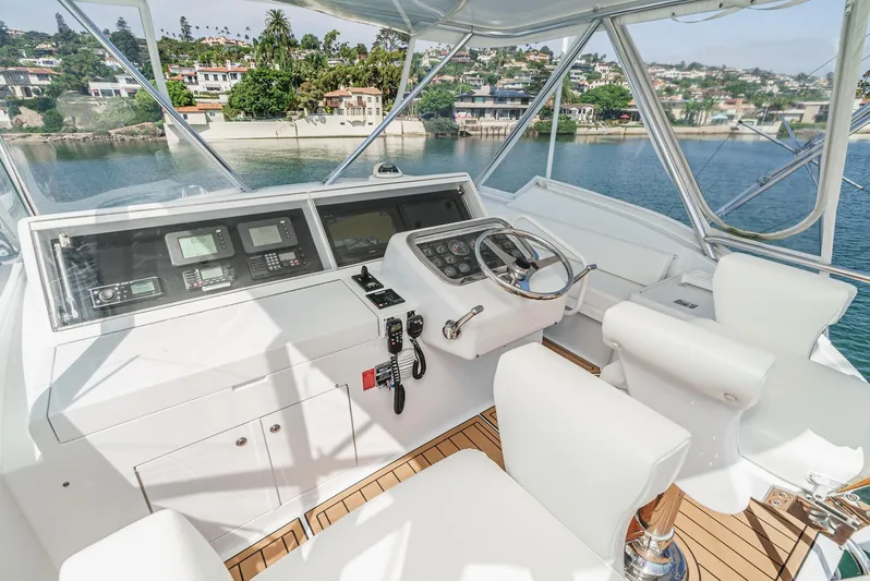 Whiplash II Yacht Photos Pics Helm of 2006 Hatteras 50 Convertible yacht with modern controls and scenic waterfront view.