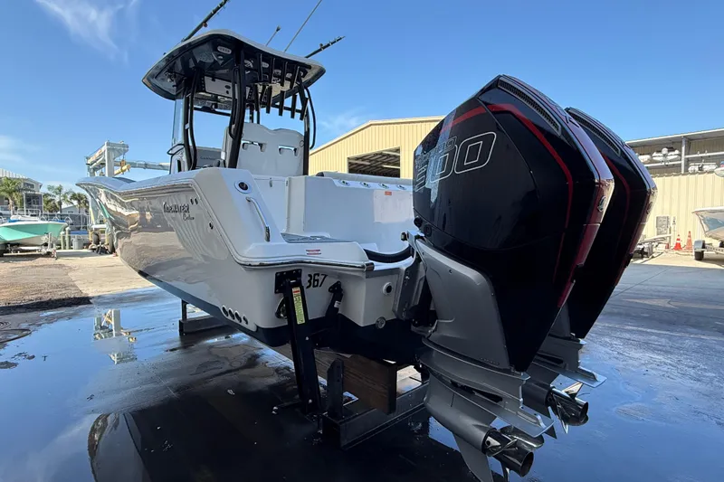  Yacht Photos Pics 2022 Tidewater 292 CC Adventure boat with dual outboard engines, docked outdoors.