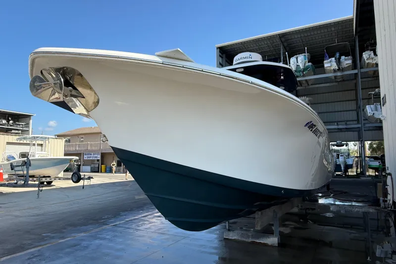  Yacht Photos Pics 2022 Tidewater 292 CC Adventure boat in marina, showcasing sleek design and modern features.