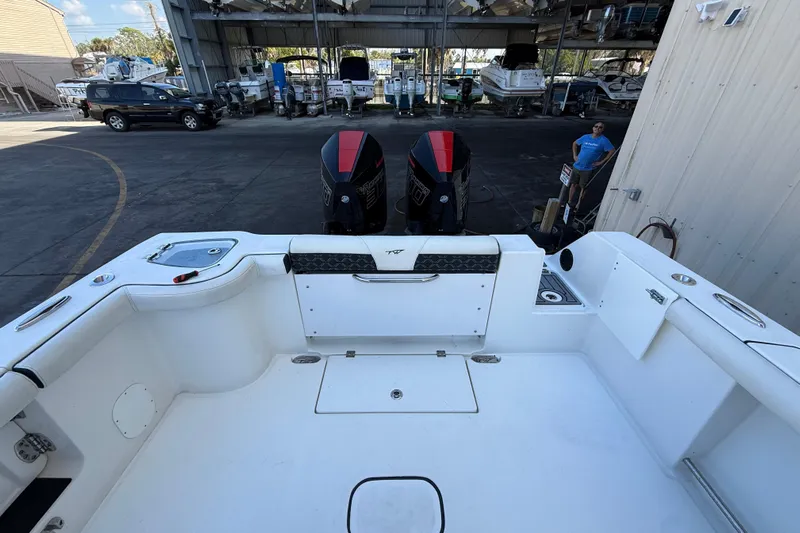  Yacht Photos Pics 2022 Tidewater 292 CC Adventure boat with dual engines in a marina setting.