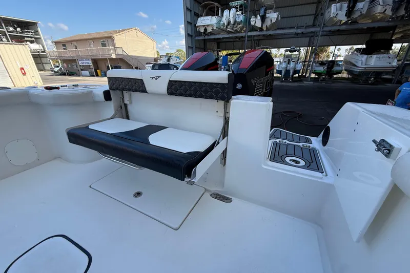  Yacht Photos Pics 2022 Tidewater 292 CC Adventure boat interior with seating and dual engines.