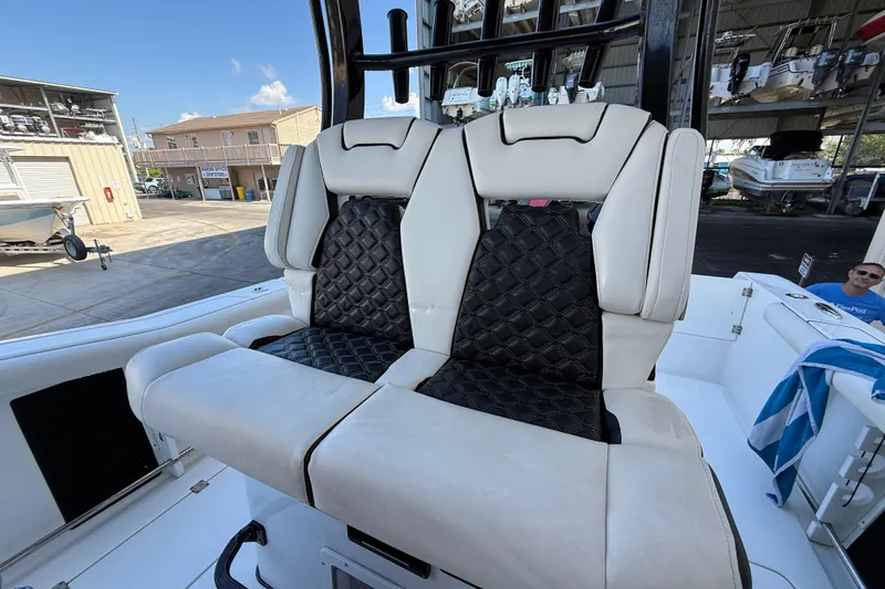  Yacht Photos Pics 2022 Tidewater 292 CC Adventure boat with luxurious dual seating in a marina setting.