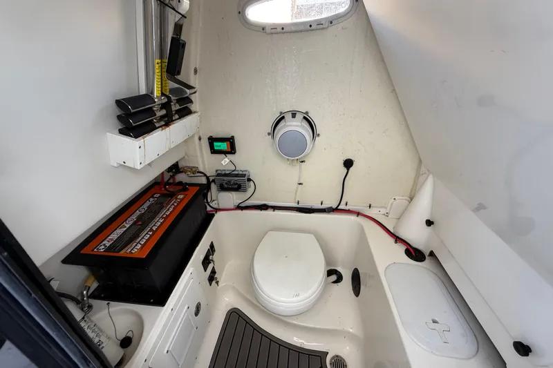  Yacht Photos Pics 2022 Tidewater 292 CC Adventure boat interior with toilet and equipment.