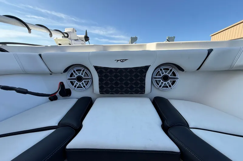  Yacht Photos Pics 2022 Tidewater 292 CC Adventure boat interior with speakers and cushioned seating.