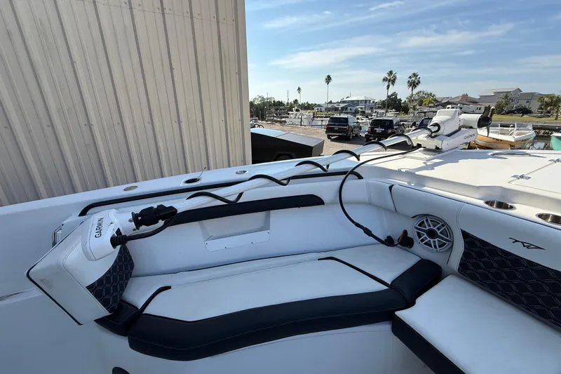  Yacht Photos Pics 2022 Tidewater 292 CC Adventure boat interior with Garmin equipment, docked near waterfront.