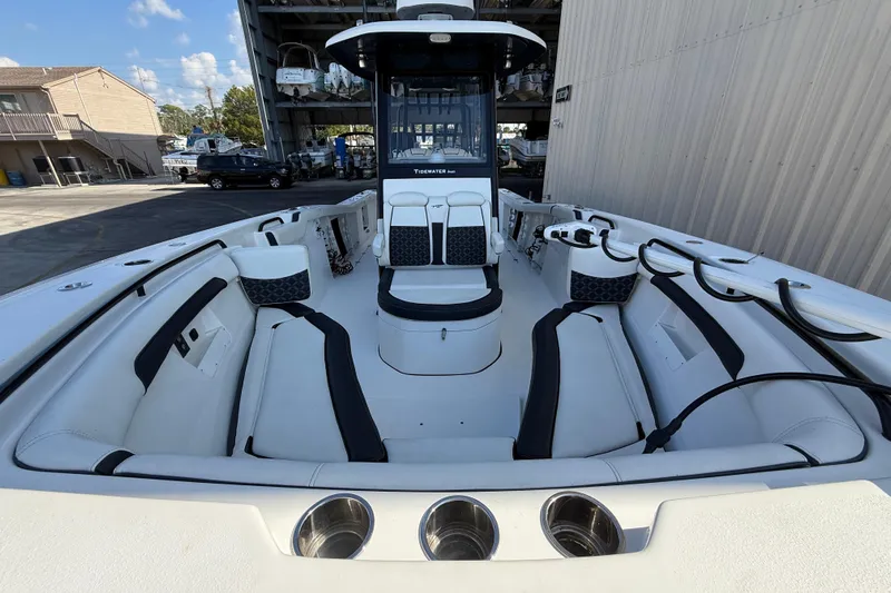  Yacht Photos Pics 2022 Tidewater 292 CC Adventure boat interior with seating and storage, docked outdoors.