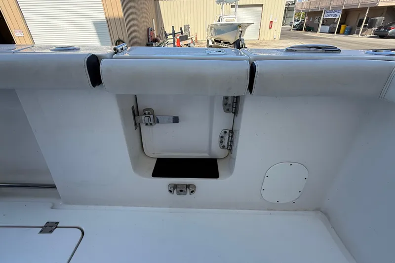  Yacht Photos Pics 2022 Tidewater 292 CC Adventure boat interior with storage compartment and latch.