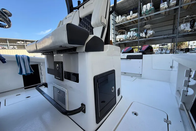  Yacht Photos Pics 2022 Tidewater 292 CC Adventure boat interior with seating and storage compartments.