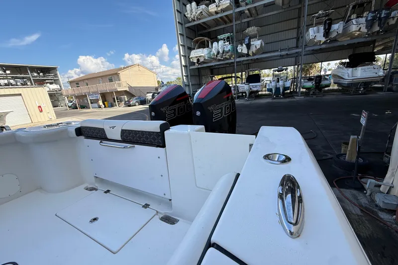  Yacht Photos Pics 2022 Tidewater 292 CC Adventure boat with dual 300 horsepower engines in a marina.