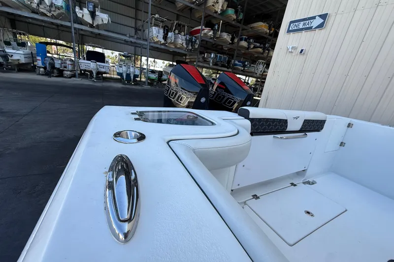  Yacht Photos Pics 2022 Tidewater 292 CC Adventure boat in storage, featuring sleek design and powerful engines.