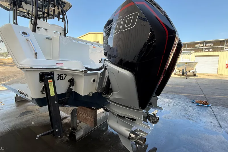  Yacht Photos Pics 2022 Tidewater 292 CC Adventure boat with powerful outboard engine in a marina setting.