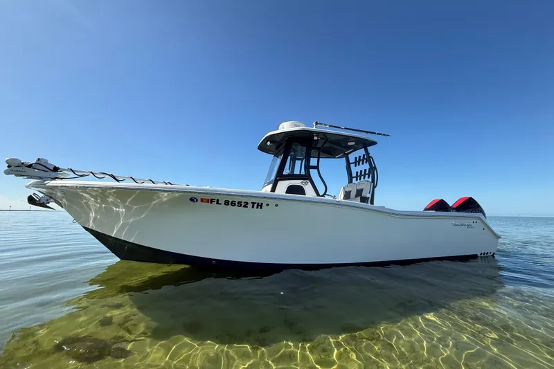  Yacht Photos Pics 2022 Tidewater 292 CC Adventure boat on clear water under blue sky.