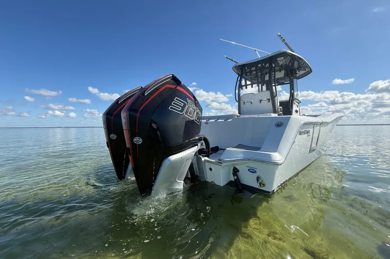  Yacht Photos Pics 2022 Tidewater 292 CC Adventure boat with dual engines in shallow water.