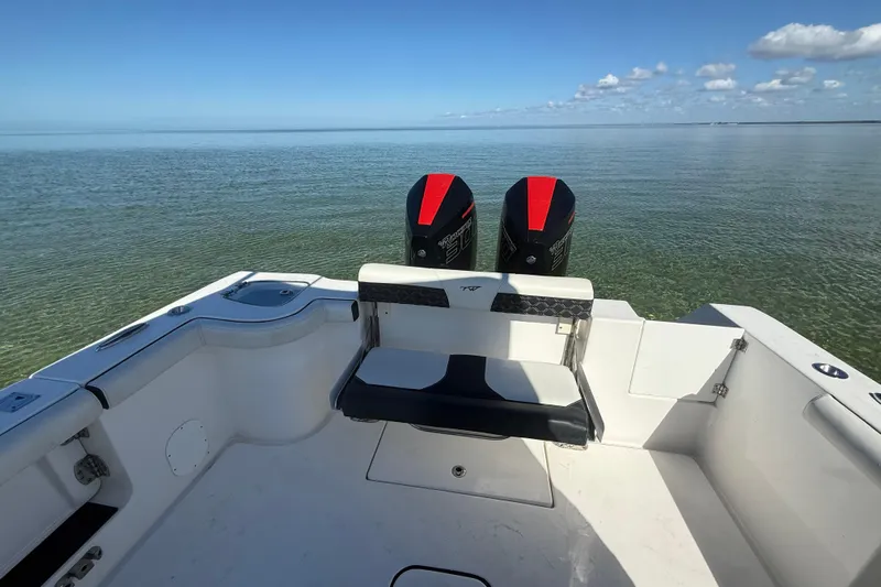  Yacht Photos Pics 2022 Tidewater 292 CC Adventure boat with dual engines on calm water.