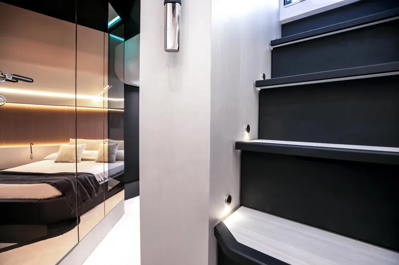  Yacht Photos Pics Modern interior of 2026 FIM 500 Regina yacht with sleek staircase and cozy bedroom.