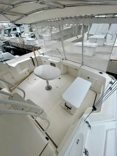  Yacht Photos Pics 2002 Riviera Convertible 37 yacht interior with seating and table, docked at marina.