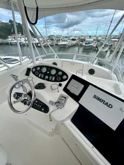  Yacht Photos Pics 2002 Riviera Convertible 37 yacht helm with Simrad navigation, docked at marina.
