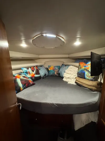  Yacht Photos Pics Cozy interior cabin of 2002 Riviera Convertible 37 with colorful cushions and modern lighting.