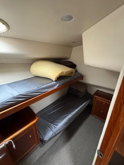  Yacht Photos Pics Interior of 2002 Riviera Convertible 37 with bunk beds and wooden cabinetry.