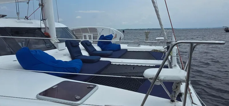 Bellagio Yacht Photos Pics 2013 Kelsall Suncat 40 catamaran with blue cushions on deck, sailing on open water.