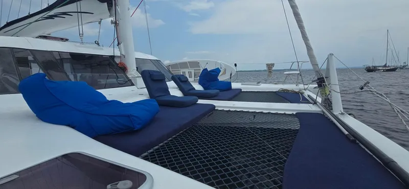 Bellagio Yacht Photos Pics Kelsall Suncat 40 catamaran, 2013 model, with blue cushions on deck, sailing on calm waters.