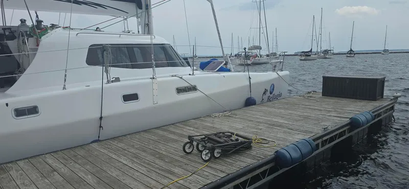 Bellagio Yacht Photos Pics Kelsall Suncat 40 catamaran docked at marina, 2013 model, with other boats in background.