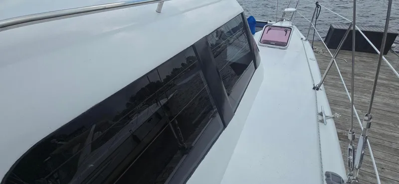 Bellagio Yacht Photos Pics 2013 Kelsall Suncat 40 yacht docked, showcasing sleek design and spacious deck.