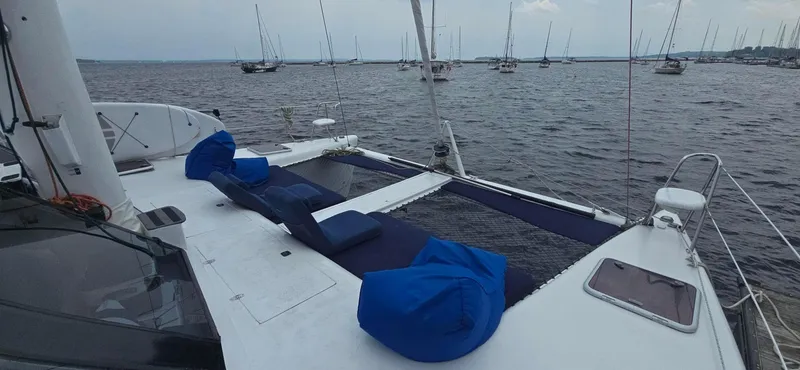 Bellagio Yacht Photos Pics Kelsall Suncat 40 catamaran, 2013 model, with blue bean bags on deck, anchored in calm waters.