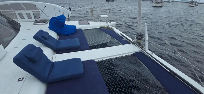 Bellagio Yacht Photos Pics Kelsall Suncat 40 catamaran deck with blue cushions, 2013 model, on calm waters.