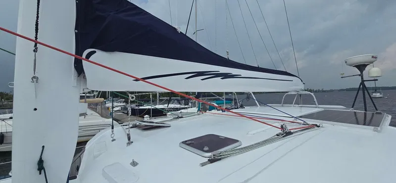 Bellagio Yacht Photos Pics Sailing yacht Kelsall Suncat 40, 2013 model, docked with sails ready, under cloudy skies.