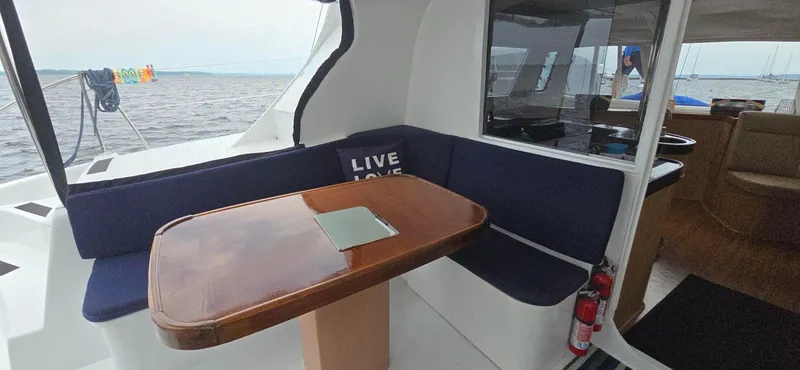 Bellagio Yacht Photos Pics Kelsall Suncat 40 yacht interior with wooden table and blue seating, 2013 model.